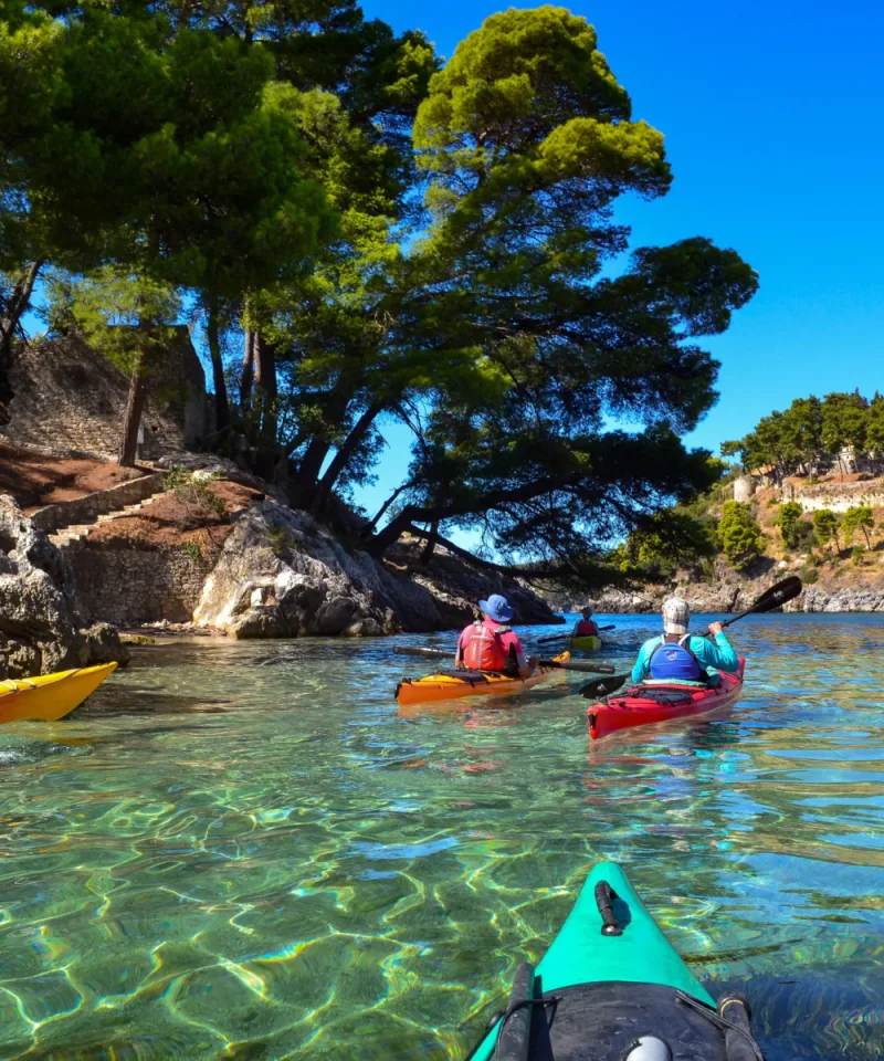 Friends enjoying a guided sea kayaking tour in Parga along the Ionian coastline