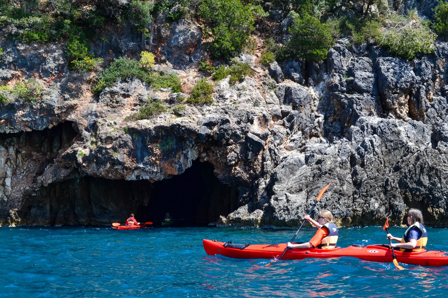 Sea kayaking into Aphrodite’s Sea Cave during a guided tour in Parga