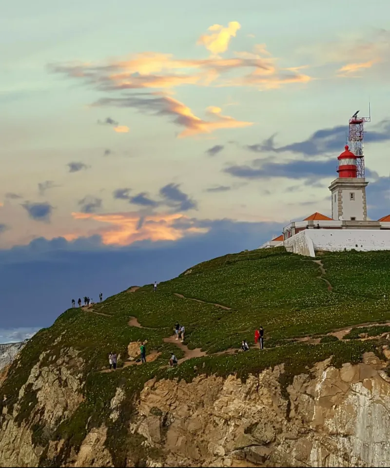 A lighthouse at the edge of a costal hiking trail in Portugal